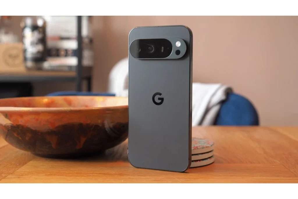 Google Pixel 10 Pro in obsidian black with signature camera bar design on a wooden table